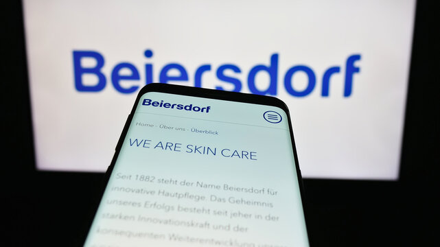 Stuttgart, Germany - 09-09-2023: Mobile phone with webpage of German consumer goods company Beiersdorf AG on screen in front of business logo. Focus on top-left of phone display.