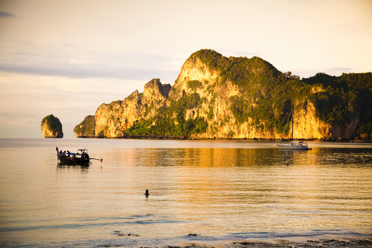 A Boat In The Water At Sunset; Phi Phi Islands, Thailand