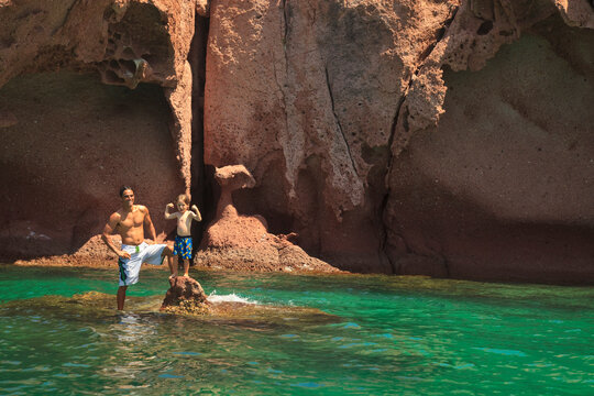 A Father And Son In The Water At Los Islotes National Marine Park Espiritu Santos Island; La Paz, Baja, California, Mexico
