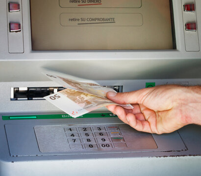 Customer Withdrawing Money From A Bank Cash Point Machine; Torremolinos, Malaga, Andalusia, Spain