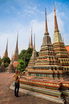 Tourist Viewing Chedi At Buddhist Temple; Bangkok, Thailand