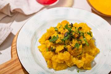 Pasta with pumpkin sauce close up. Comfortable autumn food with pumpkin and spices, vegetarian food