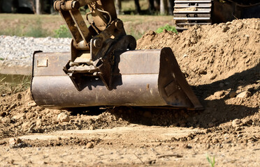 Hydraulic excavator bucket and soil close-up