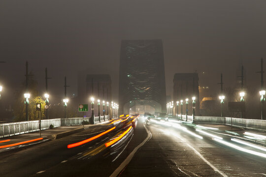 Light Trails Of Vehicle Headlights And Tail Lights On A Busy Road Leading To A Bridge At Night; Newcastle, Northumberland, England