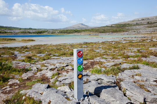 A Sign Post With Signs For Various Walking Paths In The Burren; County Clare, Ireland