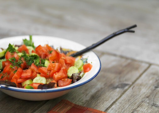 Bowl Of Salad On A Wooden Table; Lake Of The Woods, Ontario, Canada