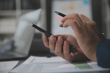 Financial Business team present. Business man hands hold documents with financial statistic stock photo, discussion, and analysis report data the charts and graphs. Finance Financial concept