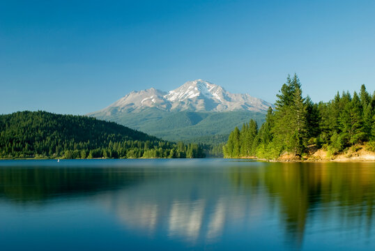 Mount shasta reflected in a tranquil lake; California united states of america