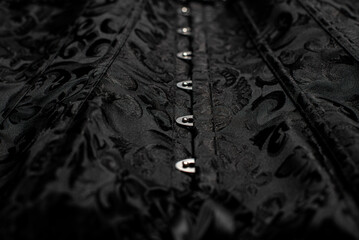 black corset and whip on the surface