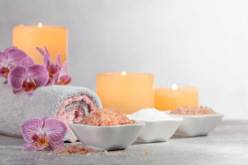 Sea salt, towels, orchid flowers, and burning candles.
