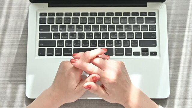 High angle view of woman hands while typing on laptop computer.