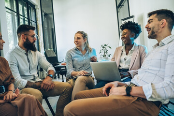 A diverse, casual business team collaborates in the office, brainstorming and creating innovative solutions and fostering in dynamic creative environment.	
