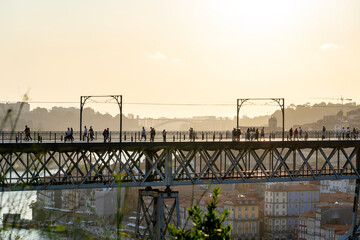 06.22.2023. Porto, Portugal: dom luiz brige in Porto on the riverside of Duero river cityscape at sunset from above with tourists - obrazy, fototapety, plakaty
