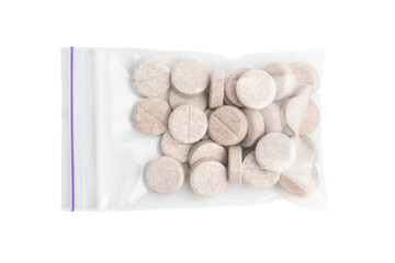 Round therapeutic pills or drugs for treatment in transparent plastic bag isolated on transparent...