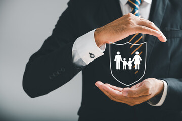 Businessman protective stance symbolizes comprehensive insurance for family, life, health, and...