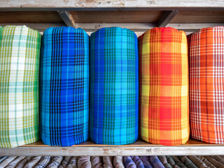 The handmade woven silk rolls with the plaid pattern.