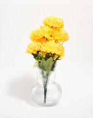 A bouquet of yellow fresh bright flowers in a glass vase. Spring flowers blooming.