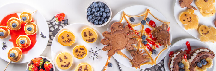Funny kids breakfast for Halloween. Creative homemade sweet pancakes in form of traditional...