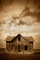 Old Abandoned House in Rural Area with Stormy Sky Sepia Toned