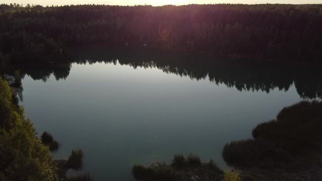 a small forest lake at sunset 60 fps