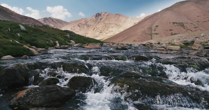 Mountain stream slow motion. Arashan. Spring mountain stream. Water flows over rocks covered with moss. Unity with nature, balance and peace. Concept of freedom and calmness in unity with nature