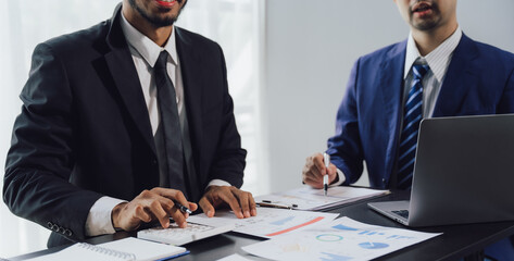 Teamwork with business people analysis cost graph on desk at meeting room. double exposure successful teamwork,business planning concept.