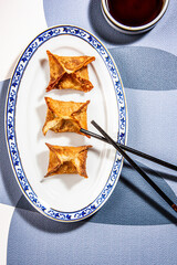 Fried wontons with soya sauce on a vibrant colorful background - 647763625