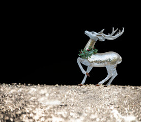 Christmas New Year background. Sparkling reindeer  a black background and sparkling. Lots of free space for your ideas and texts.
