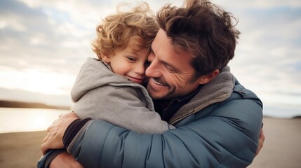 Portrait of happy father and smiling son embracing together.