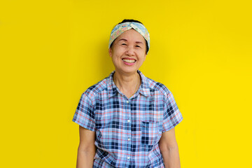 Asian woman from Thailand smiling happily.Isolated on yellow background.