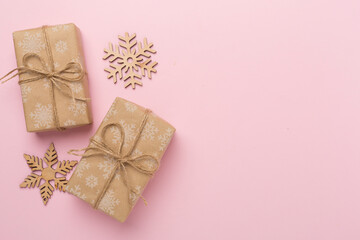 Craft christmas gift boxes on color background, top view