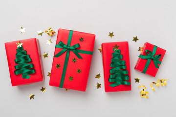 Creative handmade christmas gift boxes with decor on color background, top view