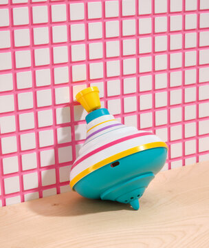 Spinning top near the wall. Toys for babies. Happy mood.