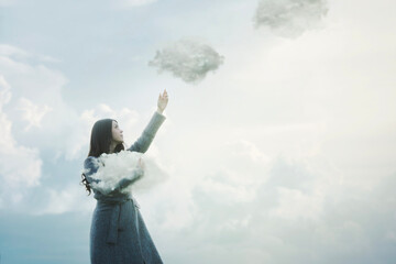 surreal woman is releasing the clouds that she was holding in her arms into the sky, abstract...