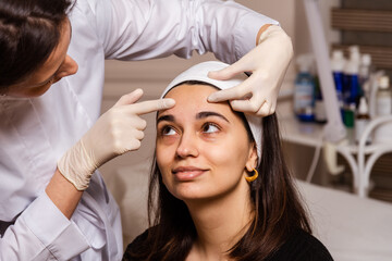 Fototapeta premium Reception, examination and procedures at the doctor of the skin care clinic