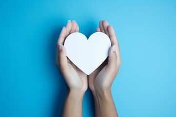 Fototapeta premium Gestures of Love: Hands Forming a Heart in White and Azure