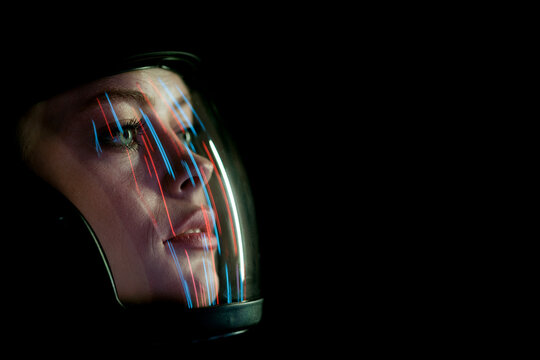 Astronaut in futuristic costume. Girl in glasses of virtual reality while touching air. Augmented reality game, future technology, AI concept. Dark background.