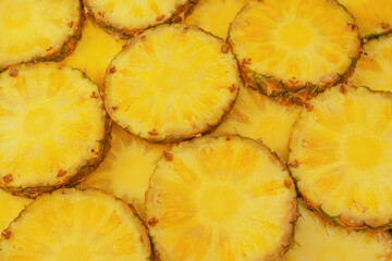 Pineapple juicy yellow slices as a background.