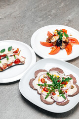 Plates with fresh salads with meat and shrimp