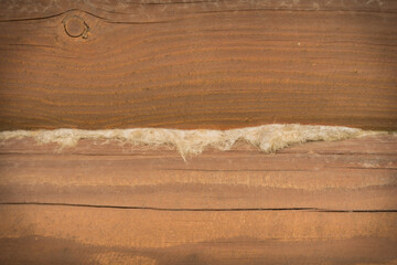 Red impregnated pine logs with interventional flax close up