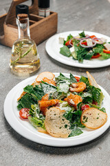 Plates with fresh salads with meat and shrimp