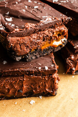 Caramel Chocolate Cheesecake Dessert Bars with Ganache Topping: Layers of chocolate crust, caramel, cheesecake filling, and dark chocolate ganache