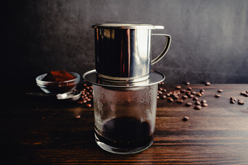 Brewing Hot Black Vietnamese Coffee (Cà Phê Den) with a Phin Filter: Vietnamese coffee being brewed with a drip filter