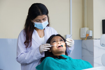Asian Dentist Checking up on her patient, Female dentist and Female Patient in a Hospital