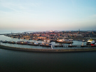 Fototapeta premium Aerial view of the city of Harlingen, at sunset in the IJsselmeer in the Netherlands.