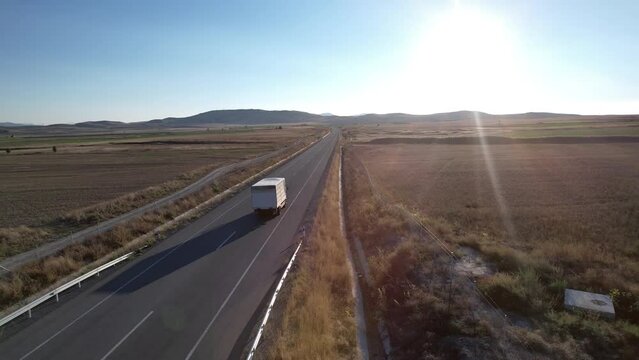Truck transportation on the road at sunset, aerial shot