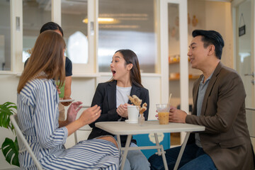 Group Business People Chatting Balcony Concept. Business people talking during coffee break. A cheerful friendly group of multicultural colleagues is sitting at the office and having coffee break.