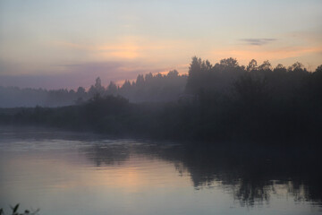 Landscape of evening fog at sunset over the river.