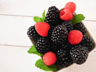 Sweet temptation: ripe blackberries and raspberries ready to eat. Healthy food.