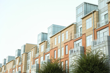 Modern building windows symbolize urban growth, business vitality, and mortgage investment, depicted in stock photo of commercial buildings against a vibrant cityscape backdrop